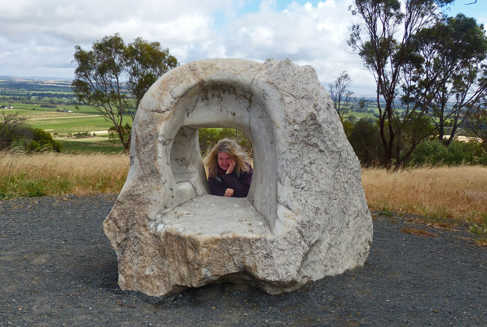 Person looking through hole in rock sculpture